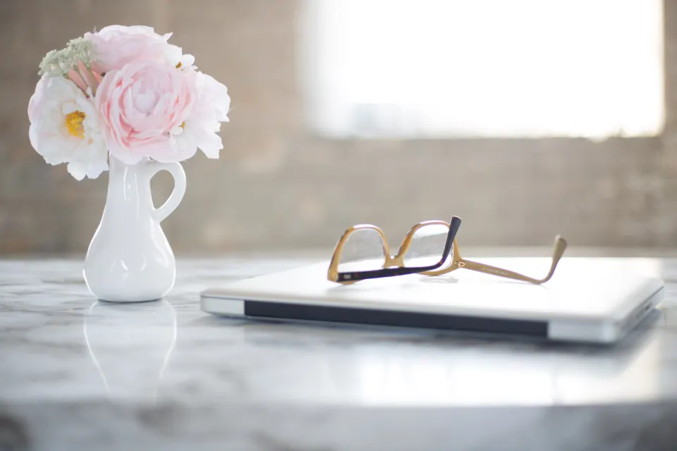 Reading glasses resting near an open book